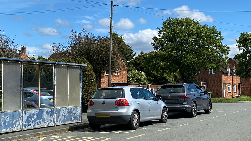 Cars parked at a bus stop