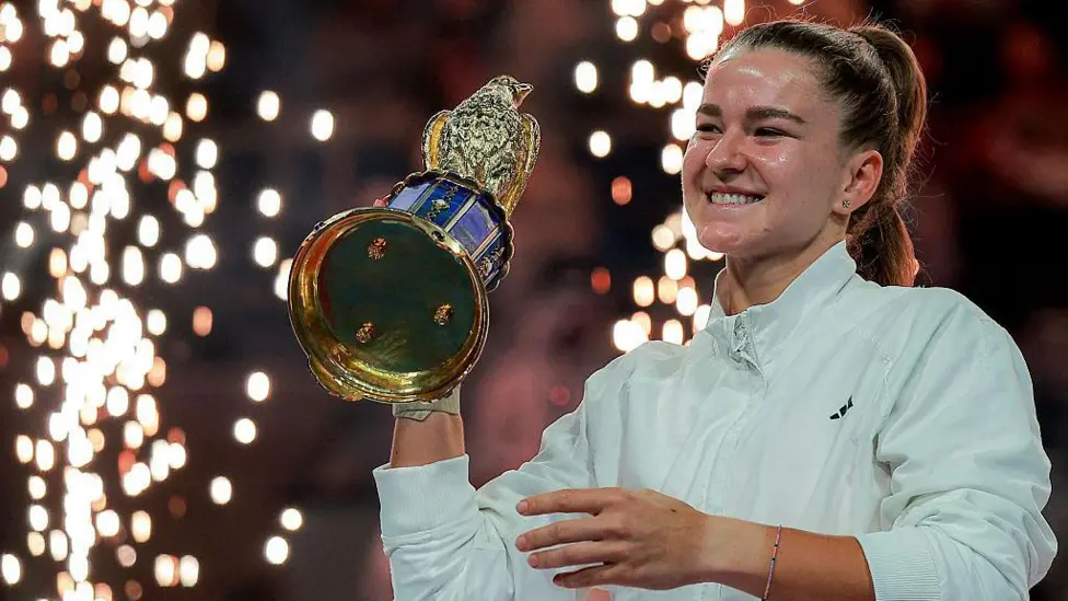 Karolina Muchova holds the Qatar Open trophy aloft