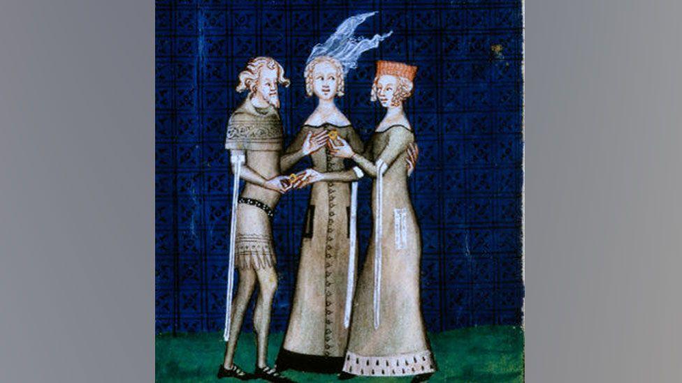 An illustration of a knight and a lady exchanging rings, c1350, from a courtly love poem by Guillaume de Machaut, the knight accepting a ring from the woman, with a second woman watching in the middle.