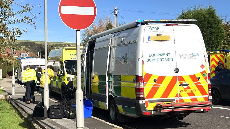 Emergency vehicles and emergency workers lining a street near Gainsborough Care Home in Dorset