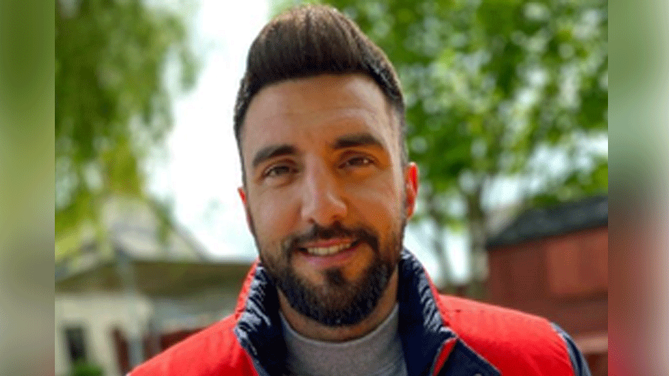 Owain James, who has brown eyes, brown hair and a beard