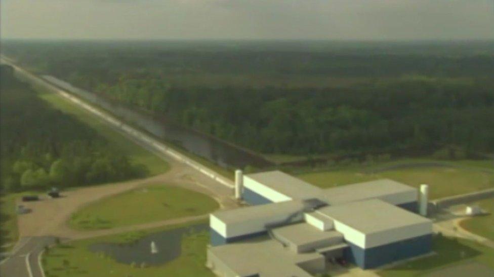 An aerial view of the LIGO experiment in Louisiana. You can see both of the laser beam pipes heading off from the main building.