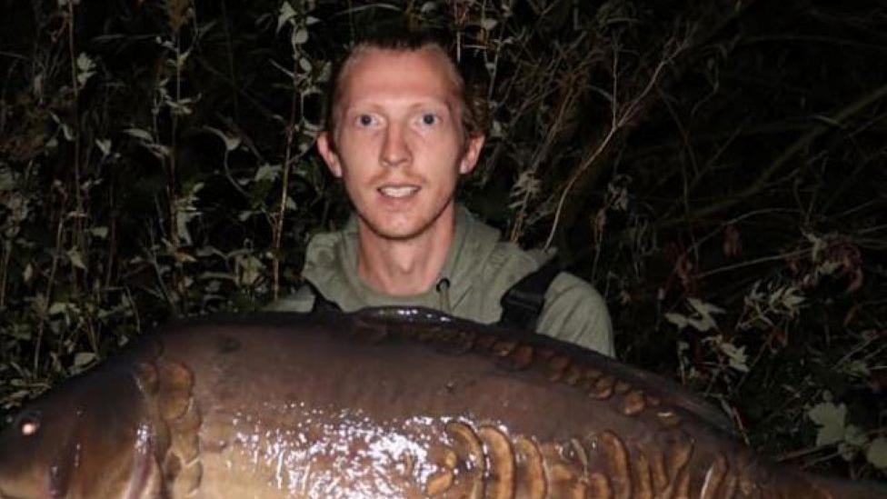 Liam McCarlie holding a fish he had caught