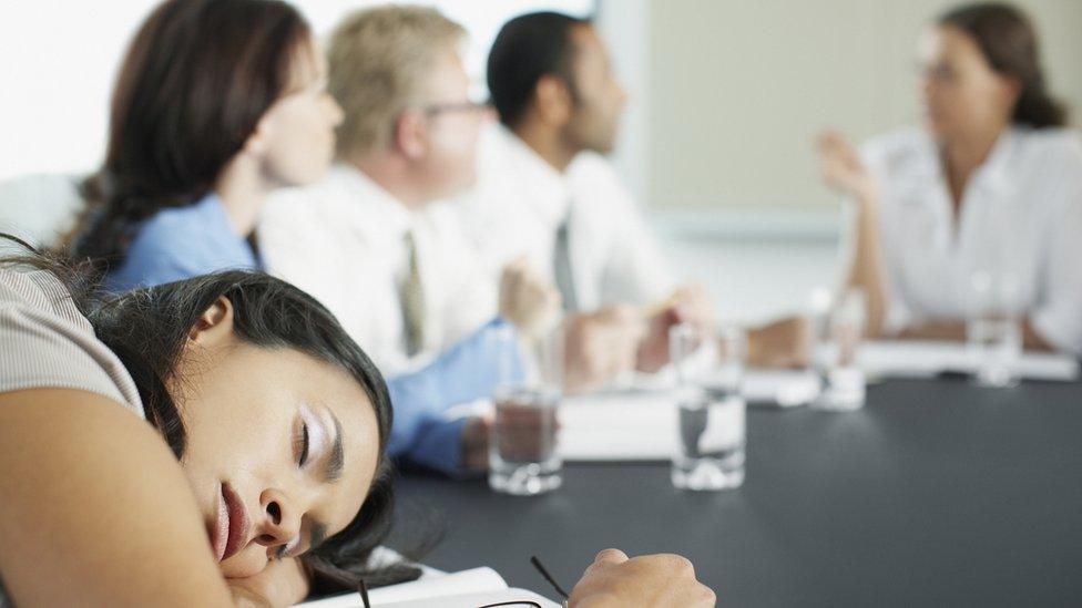 Businesswoman asleep in meeting