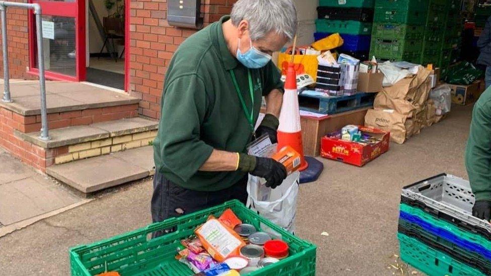 Volunteer filling a bag