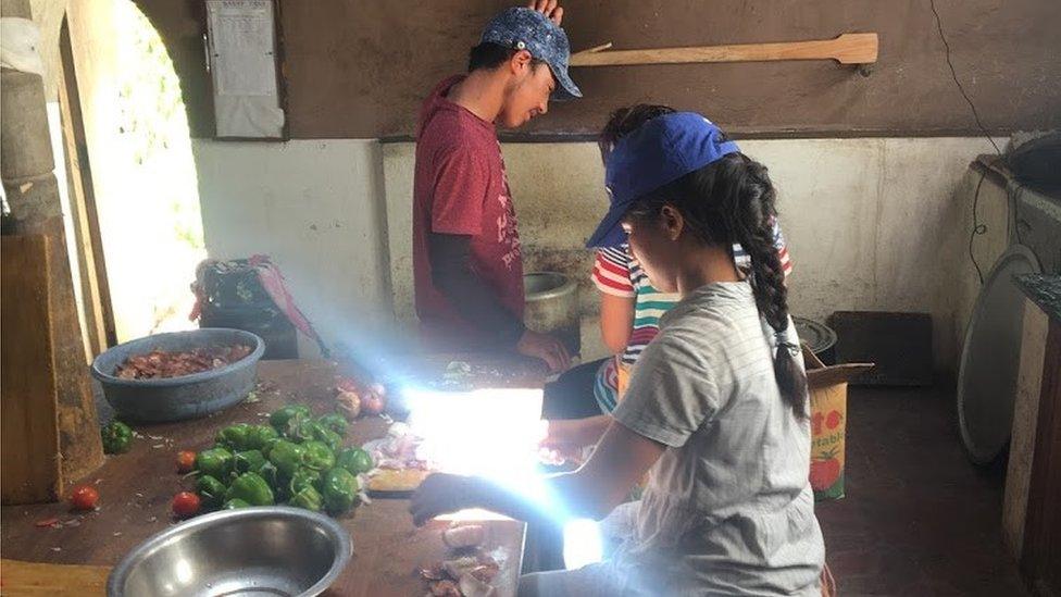 Child helping prepare food in kitchen