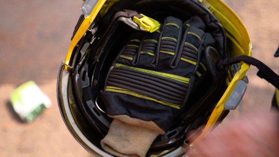 Firefighters' gloves in helmet