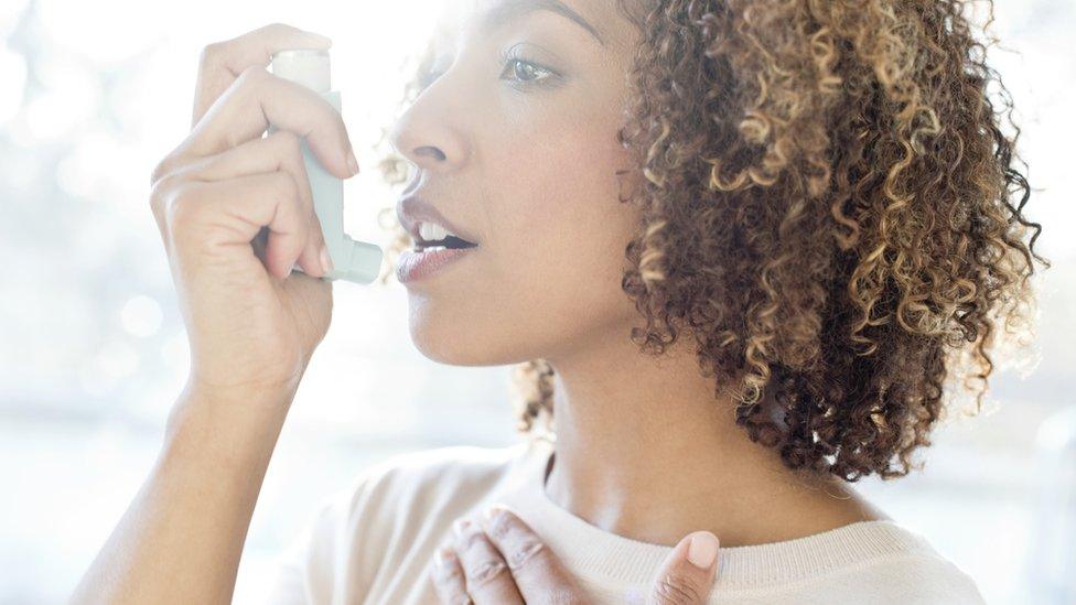 Woman using inhaler