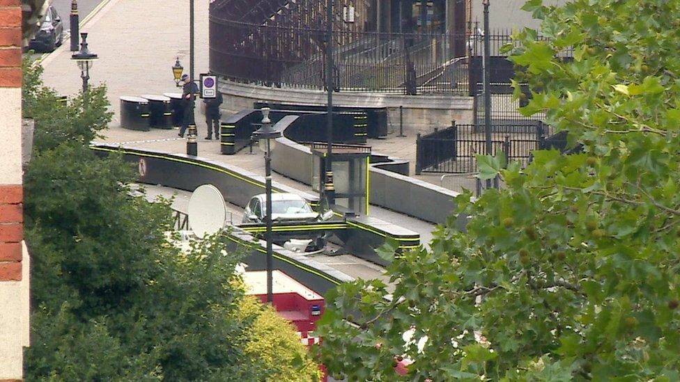 Still frame from 鶹ҳ News footage of the car which crashed into security barriers outside the Houses of Parliament.