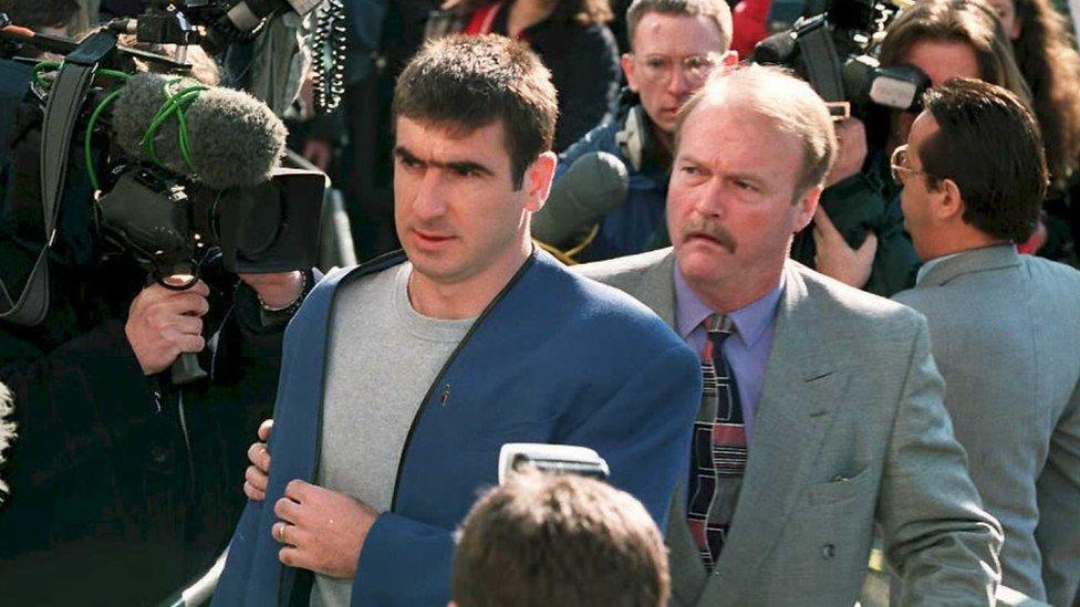 Eric Cantona entering a court room after kung-fu kicking a fan during a 1995 match between Manchester United and Crystal Palace.