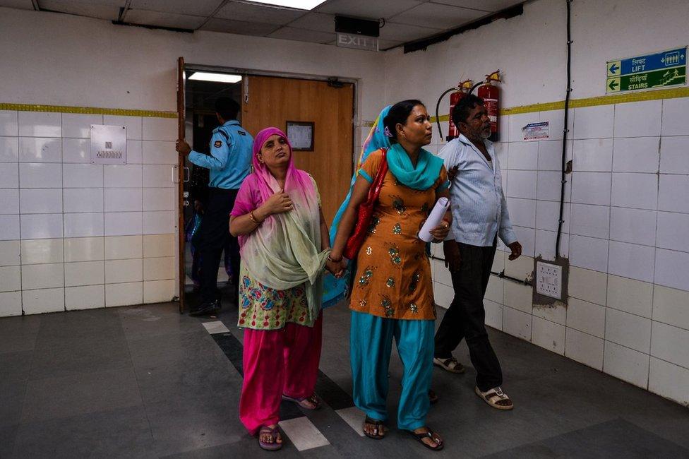 Indian patients walk in the fever ward at the Lok Nayak Hospital in New Delhi on September 2, 2016.