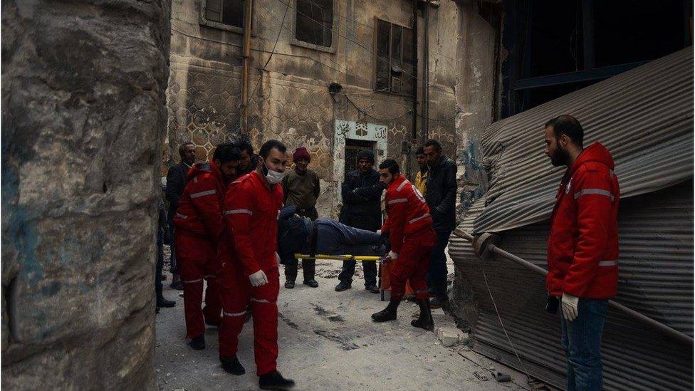 Stretcher being carried through street in eastern Aleppo by Red Crescent and Red Cross doctors, Wednesday 7 December 2016