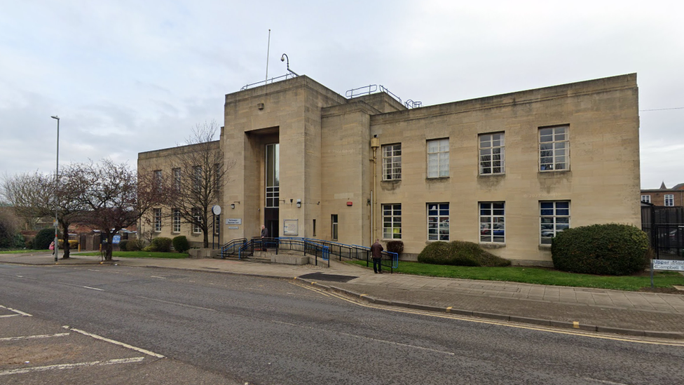 Stone-built two-storey municipal building with frontage next to road