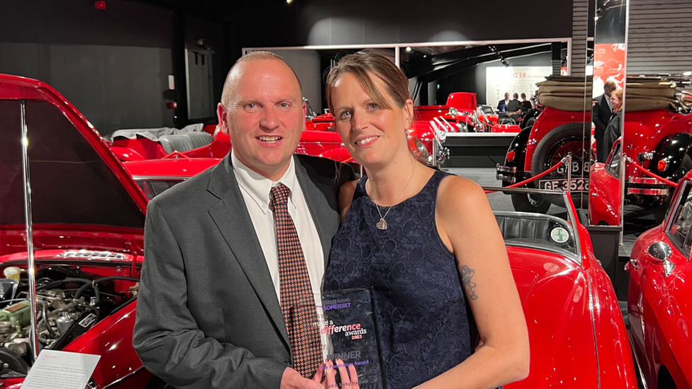 Nicky and Neil Halford holding their award