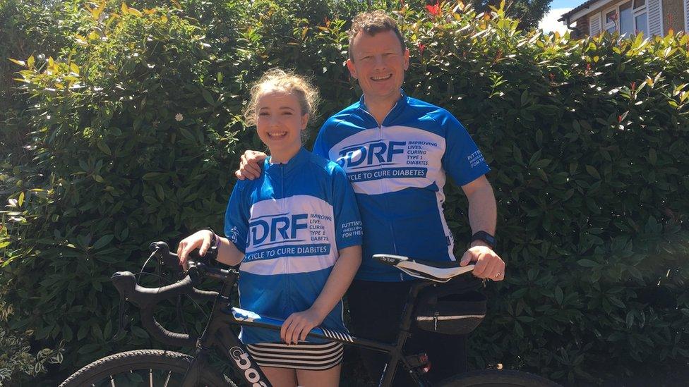 Jason Wills (right) with his daughter, Maddie (left), standing with the bike that was stolen