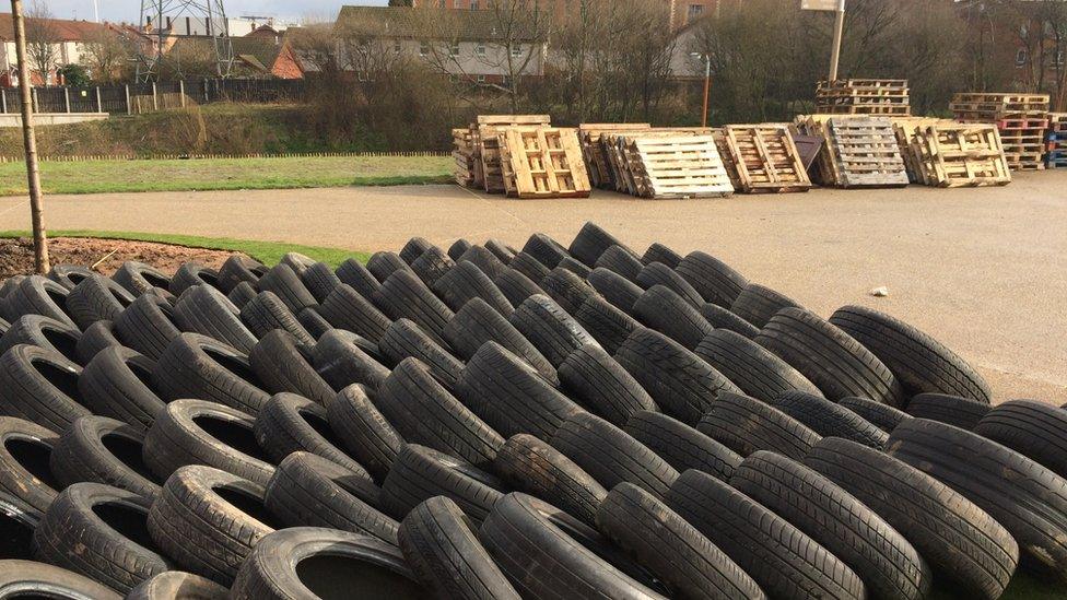 Tyres and pallets have been stockpiled along a public path on the greenway