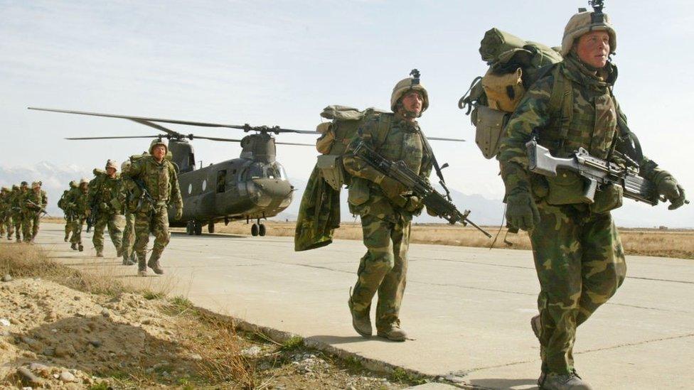 Army soldiers return to Bagram airbase from the fighting in eastern Afghanistan in March 2002