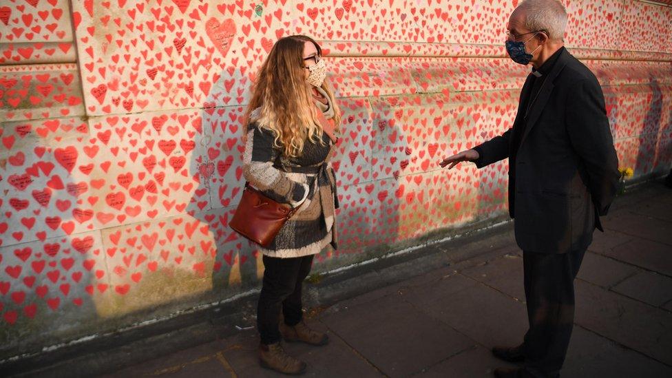 Jo Goodman speaking to the Archbishop of Canterbury next to the National Covid Memorial Wall in London