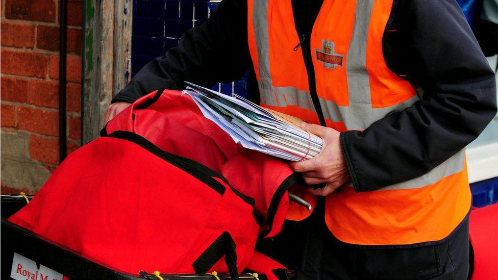 Royal Mail postal worker delivering mail