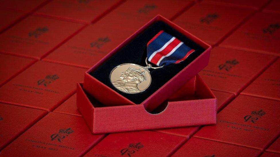 A 'thank you' medal to be given to frontline workers by the King to mark the Coronation. The medal is seen in a small red box.