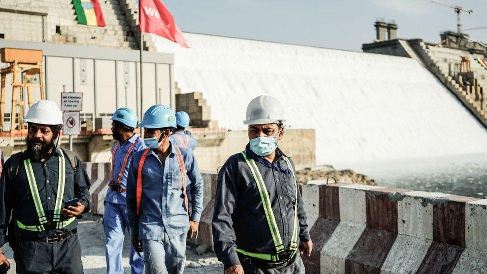 Workers walking in front of the Grand Ethiopian Renaissance Dam (Gerd)