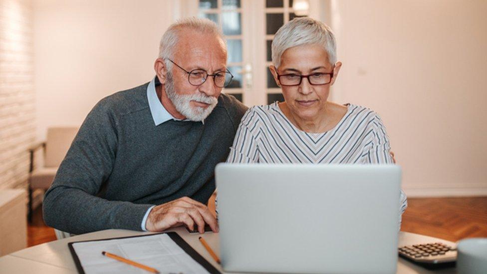 Couple looking at a computer and finances