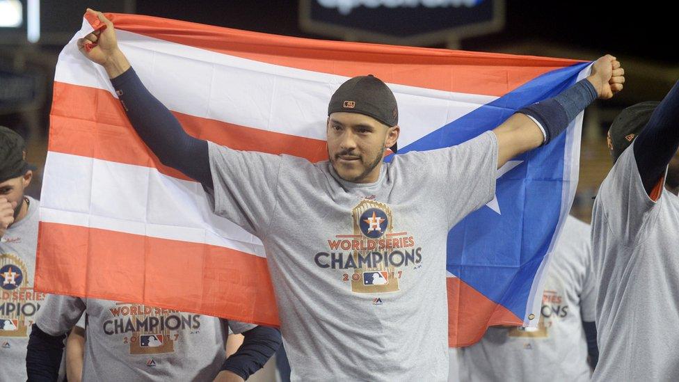 Houston Astros shortstop Carlos Correa celebrating with the Puerto Rico flag