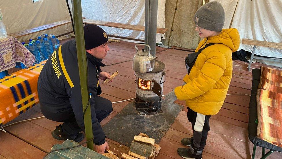 Wood-burning stoves keep young and old warm in the town of Ladyzhyn