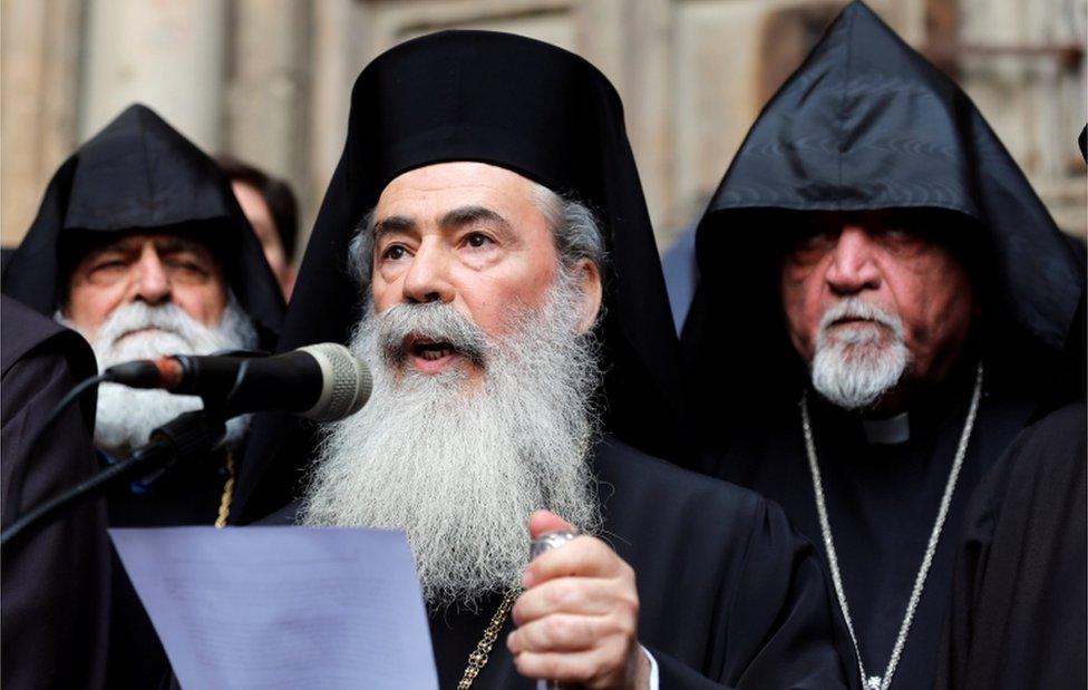 Greek Orthodox Patriarch of Jerusalem, Theophilos III, speaks during a news conference with other church leaders in front of the closed doors of the Church of the Holy Sepulchre