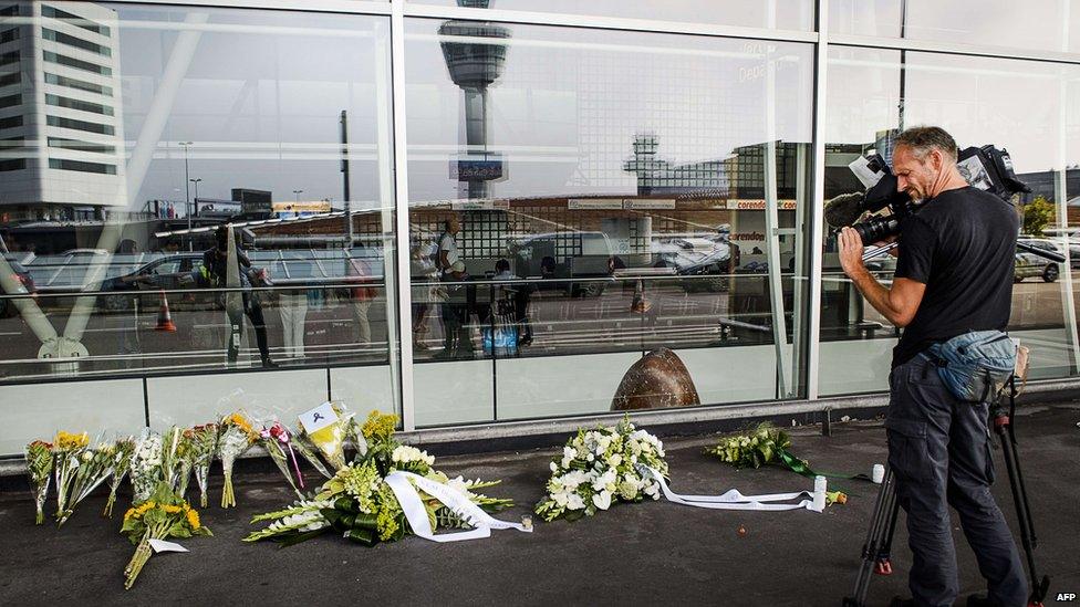 Flowers laid at departure hall three, at the airport in Schiphol, Netherlands. 17 July 2015