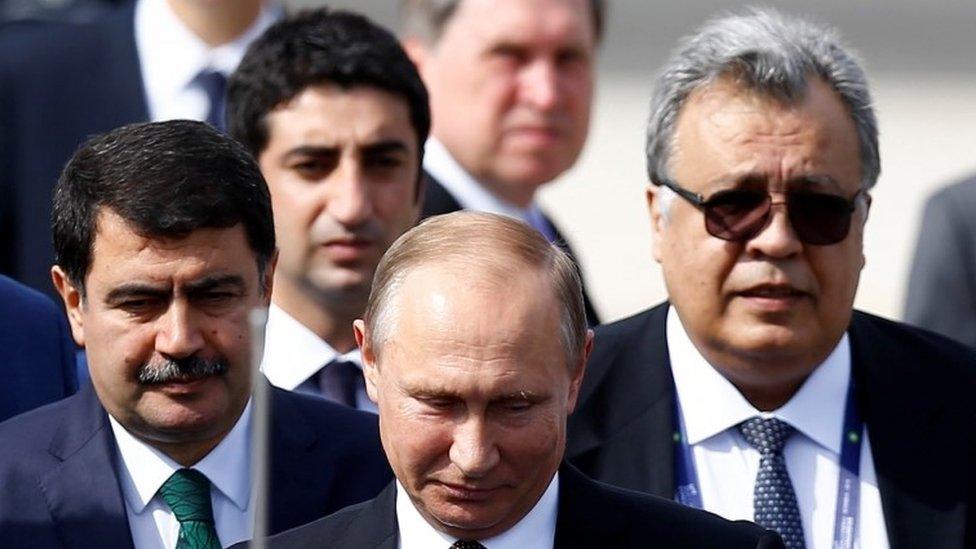 Russian Ambassador to Turkey Andrei Karlov (R) accompanies Russian President Vladimir Putin who disembarks from the Presidential aircraft at Ataturk airport in Istanbul, Turkey, October 10, 2016