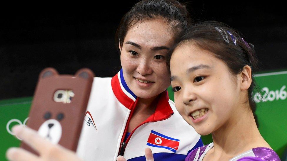 Gymnasts Lee Eun-Ju of South Korea and Hong Un Jong of North Korea (PRK) take a selfie at the Rio Olympic Arena in 2016