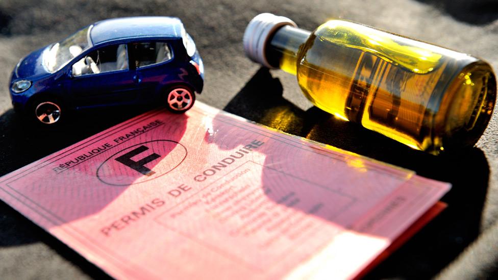 A French driving licence, a bottle of pastis and a small car