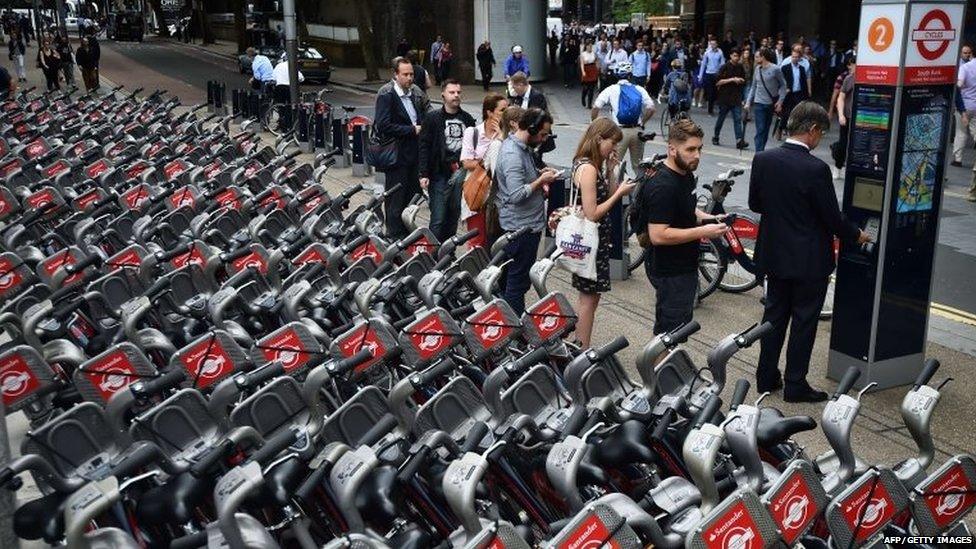 Commuters queue to hire London rental bicycles as a tube strike hits the morning rush hour in the city of London