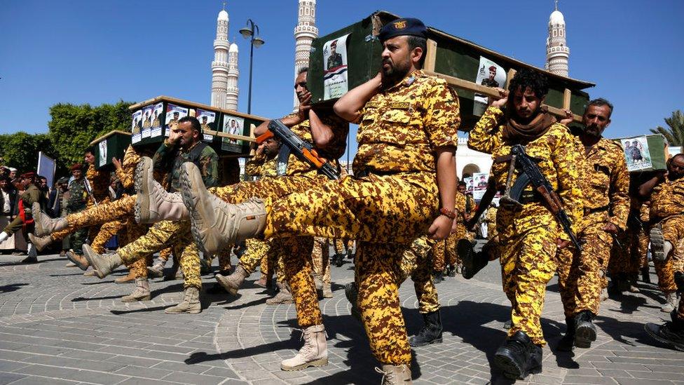 Police members carry coffins of Houthi fighters killed in recent fighting against forces of the internationally-recognized government for capturing Yemen's oil-rich Marib, during a funeral on December 06, 2021