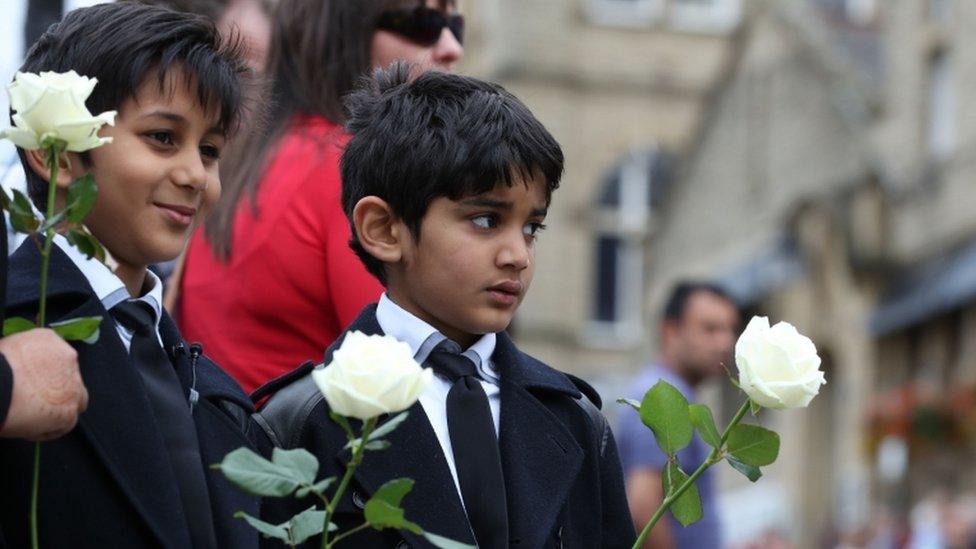 Boys holding white roses as Jo Cox funeral cortege approaches Batley