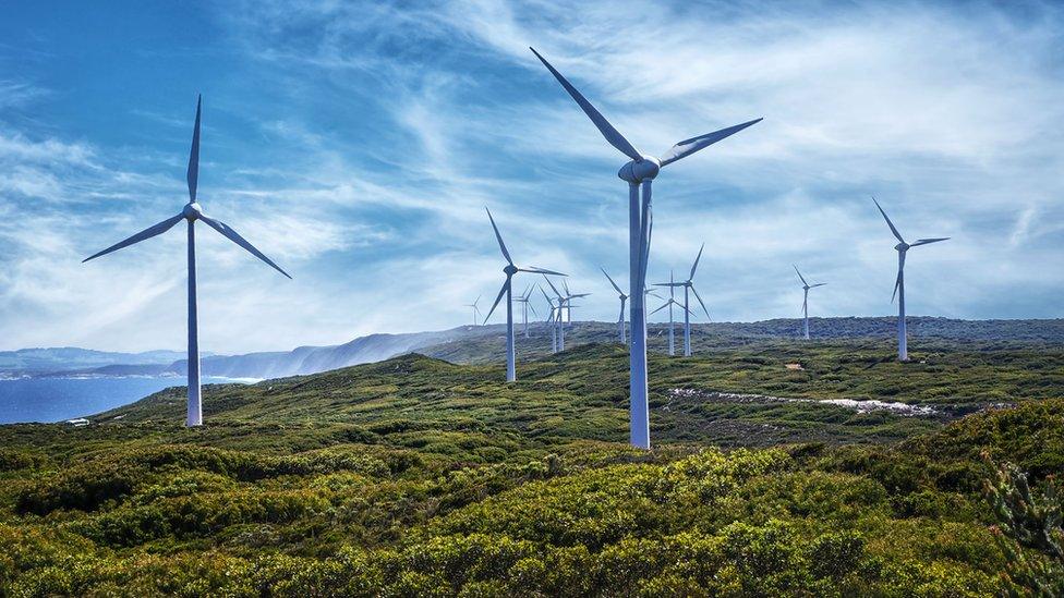 Wind turbines on a hill by the sea in Australia