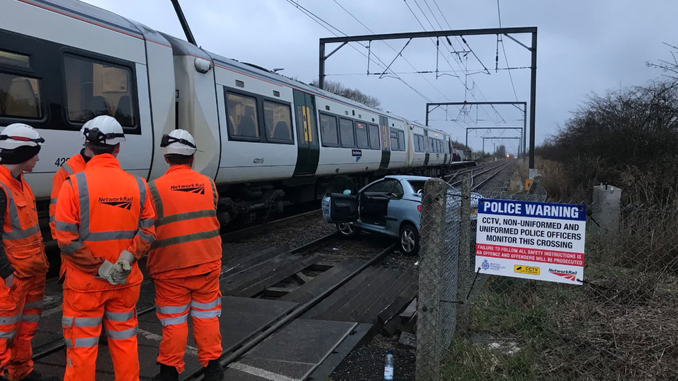 Car and train on tracks