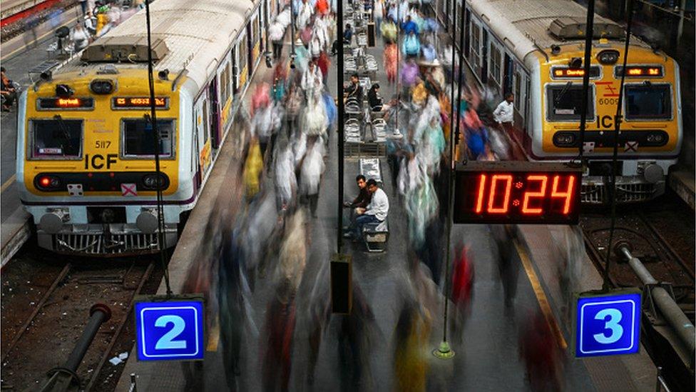 Commuters walk along platforms at the Churchgate railway station in Mumbai on January 31, 2024. (Photo by Punit PARANJPE / AFP)