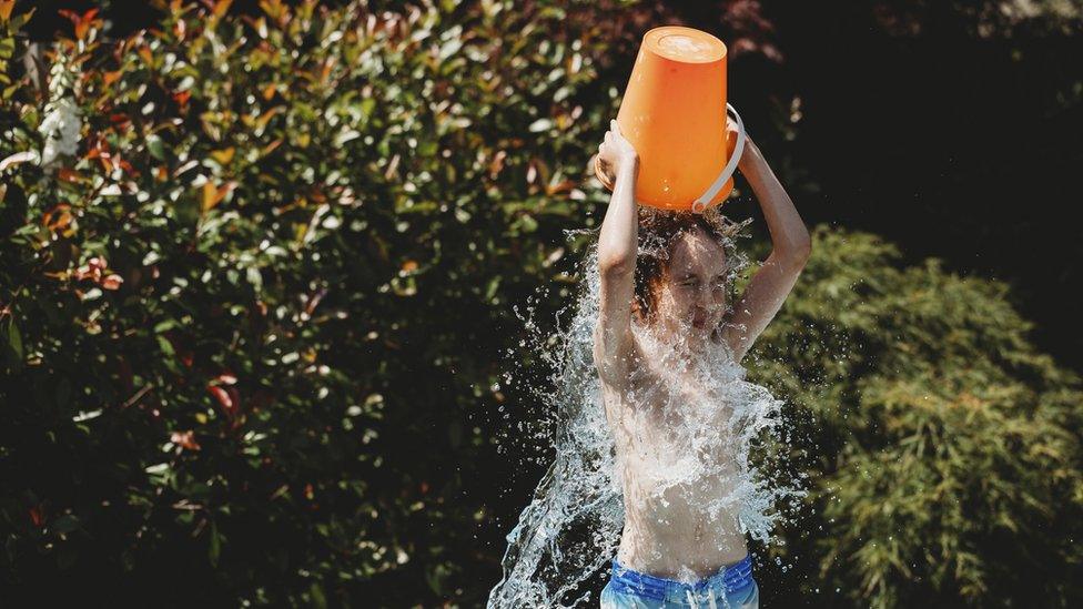 boy-tipping-water-over-his-head.