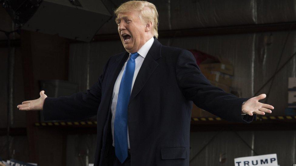 Trump holds his arms out during a speech in Ohio.