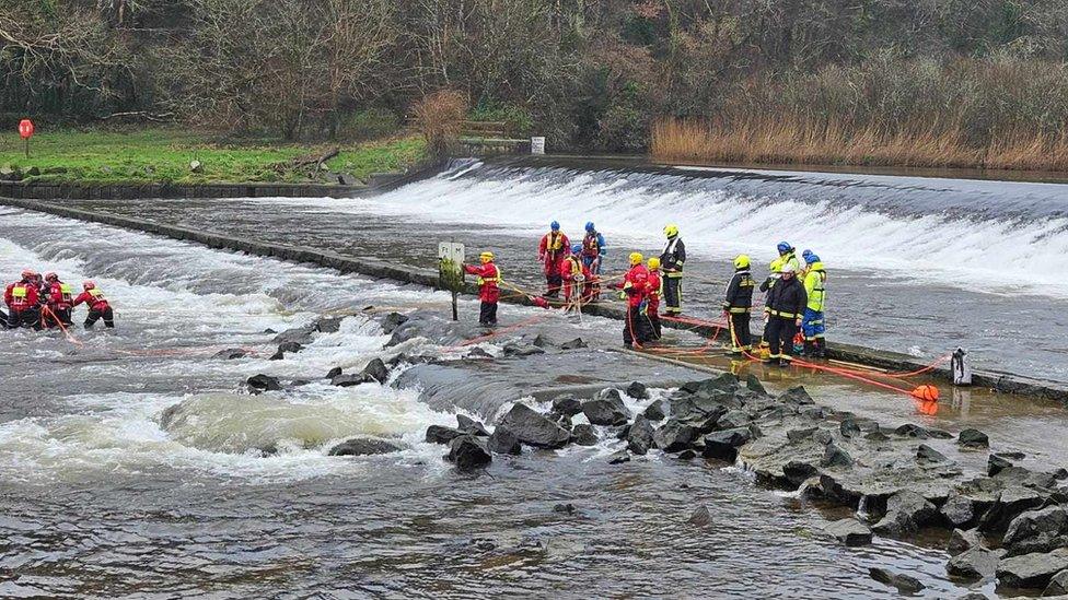 Firefighters and coastguard retrieve a motorbike