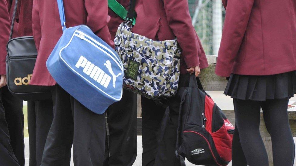 Pupils wearing school uniform gathering outside