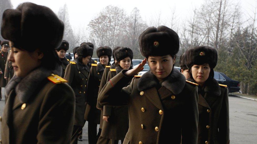 Members of the North Korean ensemble Moranbong and the State Merited Chorus prepare to leave for China at Pyongyang station on 9 December 2015.