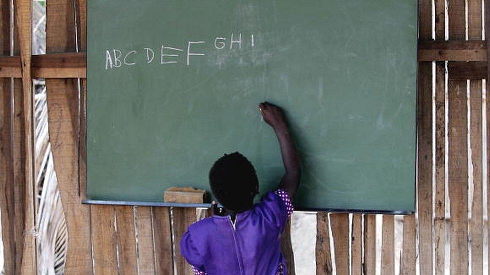 Girl writing on the blackboard