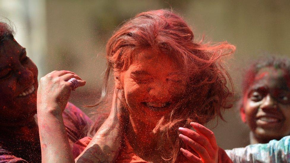 A woman playing Holi