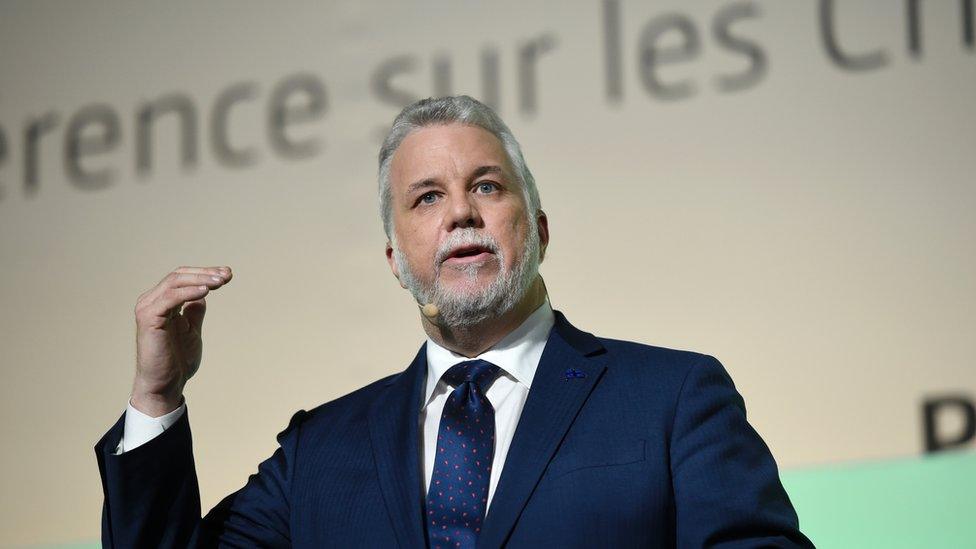 Quebec Premier Philippe Couillard delivers a speech during the opening of 'Action Day' at the COP21 United Nations conference on climate change in Le Bourget on December 5, 2015.