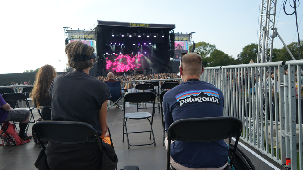 People on the viewing platform watching the stage