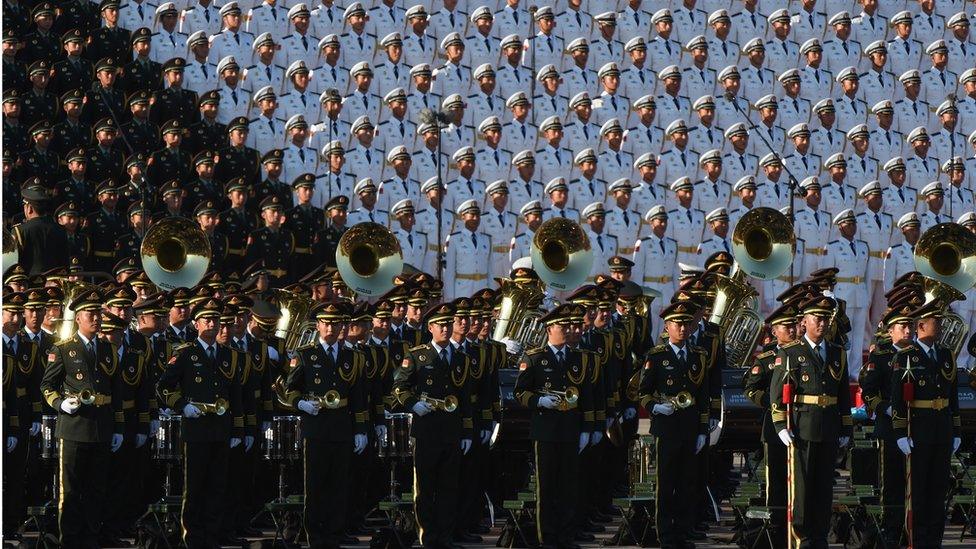 A Chinese military brass band (front) and choir stand in position ahead of a military parade later in the morning at Tiananmen Square in Beijing on 3 September 2015, to mark the 70th anniversary of victory over Japan and the end of World War II.