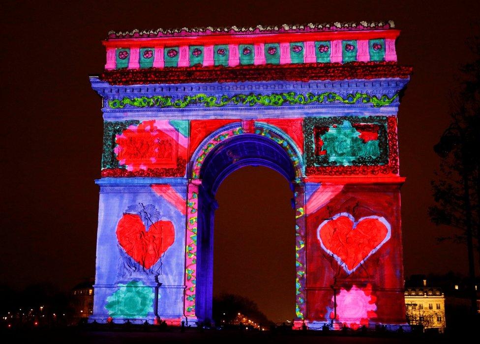 View of a light show on the city's iconic Arc de Triomphe monument during the New Year celebration in Paris, France